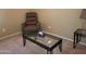 Living room featuring an armchair and a glass-top coffee table at 1769 E Jacob St, San Tan Valley, AZ 85140