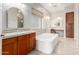 Primary bathroom featuring a soaking tub, separate vanities, and neutral finishes at 18359 W Sweet Acacia Dr, Goodyear, AZ 85338