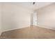 Neutral bedroom with tile flooring and adjacent doorway at 18359 W Sweet Acacia Dr, Goodyear, AZ 85338