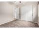 A carpeted bedroom with a fan and double door closet at 18359 W Sweet Acacia Dr, Goodyear, AZ 85338
