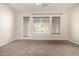 Bright bedroom with neutral walls, carpet flooring, a ceiling fan, and natural light at 18359 W Sweet Acacia Dr, Goodyear, AZ 85338