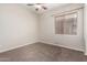 Neutral bedroom featuring carpet, ceiling fan, and window at 18359 W Sweet Acacia Dr, Goodyear, AZ 85338