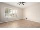 Neutral bedroom with tile flooring, shutters, and natural light at 18359 W Sweet Acacia Dr, Goodyear, AZ 85338