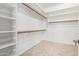 Walk-in closet with built-in shelving and tile flooring at 18359 W Sweet Acacia Dr, Goodyear, AZ 85338