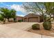 Well-kept home with lush front yard landscaping and a spacious driveway at 18359 W Sweet Acacia Dr, Goodyear, AZ 85338