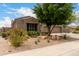 Lovely home with desert landscaping, mature trees, and a spacious driveway at 18359 W Sweet Acacia Dr, Goodyear, AZ 85338