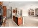 Gourmet kitchen open to living space with granite countertops and a large center island at 18359 W Sweet Acacia Dr, Goodyear, AZ 85338