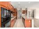 Bright kitchen showcases stainless steel appliances, granite countertops, and island with sink at 18359 W Sweet Acacia Dr, Goodyear, AZ 85338