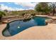 Backyard pool features a rock waterfall, desert landscaping and mountain views at 18359 W Sweet Acacia Dr, Goodyear, AZ 85338