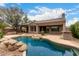 A luxurious backyard oasis with a sparkling blue pool at 18359 W Sweet Acacia Dr, Goodyear, AZ 85338