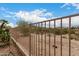 View of backyard fence, desert landscaping and partial mountain view at 18359 W Sweet Acacia Dr, Goodyear, AZ 85338