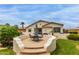 Backyard with lush lawn, patio with outdoor seating and desert landscaping at 18415 W Capistrano Ave, Goodyear, AZ 85338