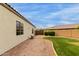 Backyard area featuring gravel and grass, leading to a fence and gate at 18415 W Capistrano Ave, Goodyear, AZ 85338