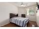 Bedroom featuring a ceiling fan, a large window, and a dresser with drawers at 18415 W Capistrano Ave, Goodyear, AZ 85338