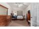 Spacious bedroom featuring a dresser, a large bed, and a window with blinds at 18415 W Capistrano Ave, Goodyear, AZ 85338