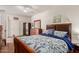 Bedroom featuring ample closet space, a dresser with mirror, and a large bed at 18415 W Capistrano Ave, Goodyear, AZ 85338