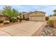 Attractive single-story house with a two-car garage and a long concrete driveway at 18415 W Capistrano Ave, Goodyear, AZ 85338