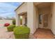 Cozy front porch with seating, beautiful landscaping, and a decorative security door at 18415 W Capistrano Ave, Goodyear, AZ 85338