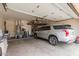 Garage featuring a silver SUV parked on the floor, plenty of storage space and accessories at 18415 W Capistrano Ave, Goodyear, AZ 85338