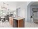 Open-concept kitchen features a kitchen island with a sink and a view of the living room and hallway at 18415 W Capistrano Ave, Goodyear, AZ 85338
