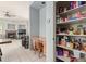 Walk-in pantry with organized shelving, conveniently located near the kitchen and living area at 18415 W Capistrano Ave, Goodyear, AZ 85338