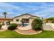 Inviting backyard pool with rock features and lush landscaping, ideal for outdoor relaxation and entertaining at 18415 W Capistrano Ave, Goodyear, AZ 85338
