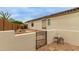 Gated side yard with desert landscaping, offering a private outdoor space at 18415 W Capistrano Ave, Goodyear, AZ 85338