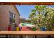 From the bar looking out to a pool, hammock and palm trees, an outdoor paradise awaits at 18662 W Foothill Dr, Surprise, AZ 85387