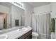Clean bathroom with a single sink vanity and a shower with a curtain at 18662 W Foothill Dr, Surprise, AZ 85387
