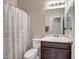 Bathroom vanity with dark wood cabinets, a sink, and a shower in the background at 18662 W Foothill Dr, Surprise, AZ 85387