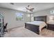 Comfortable bedroom featuring a large bed, neutral tones, and ample natural light through the window at 18662 W Foothill Dr, Surprise, AZ 85387