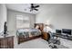 Bedroom featuring a wooden frame bed, a nightstand, and a window for lighting at 18662 W Foothill Dr, Surprise, AZ 85387