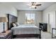 Bedroom features a dark wood frame bed and a window with backyard views at 18662 W Foothill Dr, Surprise, AZ 85387