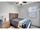 Cozy bedroom with a wooden frame bed and a window for natural light at 18662 W Foothill Dr, Surprise, AZ 85387
