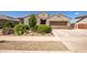 Charming single-story home with well-manicured landscaping, desert accents, and a welcoming entrance at 18662 W Foothill Dr, Surprise, AZ 85387