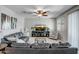 Cozy living room with comfortable seating, a ceiling fan, and a TV for entertainment at 18662 W Foothill Dr, Surprise, AZ 85387