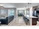 Open-concept living space with tile flooring, modern lighting, and a view of the backyard pool at 18662 W Foothill Dr, Surprise, AZ 85387