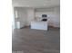 Bright kitchen boasts an island, white cabinets, stainless steel appliances and sleek tile flooring at 18795 E Bruno Dr, Gold Canyon, AZ 85118