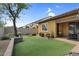 Serene backyard features a well manicured lawn, mature trees, and a patio area at 19291 E Thornton Rd, Queen Creek, AZ 85142