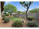 Beautiful backyard featuring artificial turf, mature trees, landscaping, and a built-in barbecue at 19291 E Thornton Rd, Queen Creek, AZ 85142