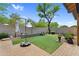 Beautiful backyard with stone retaining wall, an umbrella, and manicured landscaping at 19291 E Thornton Rd, Queen Creek, AZ 85142