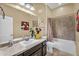 Bathroom with a single sink vanity, tile shower, and a framed mirror at 19291 E Thornton Rd, Queen Creek, AZ 85142