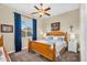 Comfortable bedroom with a wooden bed frame, blue accents, and a window bringing in natural light at 19291 E Thornton Rd, Queen Creek, AZ 85142