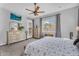 Bright bedroom with a ceiling fan, large window, and dual dressers at 19291 E Thornton Rd, Queen Creek, AZ 85142