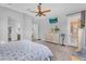Spacious bedroom with ceiling fan, television, dresser, and walk-in closet at 19291 E Thornton Rd, Queen Creek, AZ 85142
