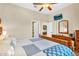Bright bedroom featuring a dresser, closet, and a comfortable bed with a patterned quilt at 19291 E Thornton Rd, Queen Creek, AZ 85142
