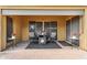 Cozy covered patio with comfortable seating, a stylish rug, and views of the serene backyard at 19291 E Thornton Rd, Queen Creek, AZ 85142