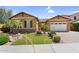 Lovely home with a tile roof, well-maintained lawn, palm trees, and a two-car garage at 19291 E Thornton Rd, Queen Creek, AZ 85142