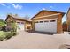 A charming, Southwestern style home with a brick driveway and multiple garage spaces for plenty of storage at 19291 E Thornton Rd, Queen Creek, AZ 85142