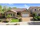 Charming single-Gathering home showcasing a well-manicured lawn, beautiful shrubbery, and a two-car garage at 19291 E Thornton Rd, Queen Creek, AZ 85142